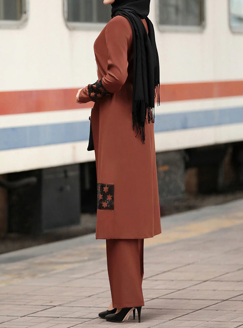 Side profile of a woman wearing rust modest tunic set, black hijab, and high heels.